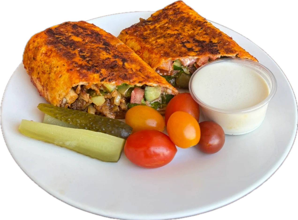 Kolaj Beef Doner Wrap - Beef doner, tomato, red onion, parsley, pickles, tahini sauce, and pomegranate molasses.